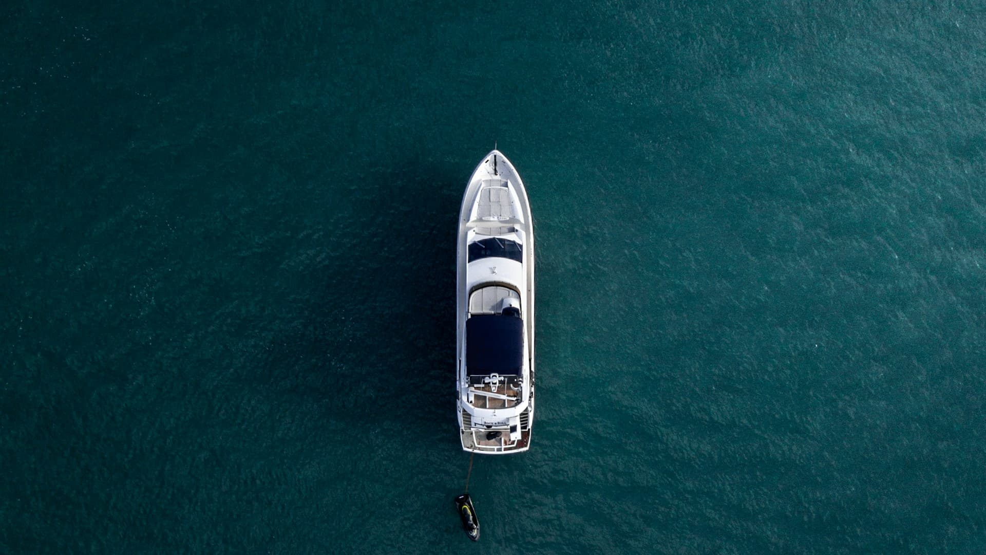 Aerial view of a superyacht on calm waters — certificate renewals must stay ahead of charter season